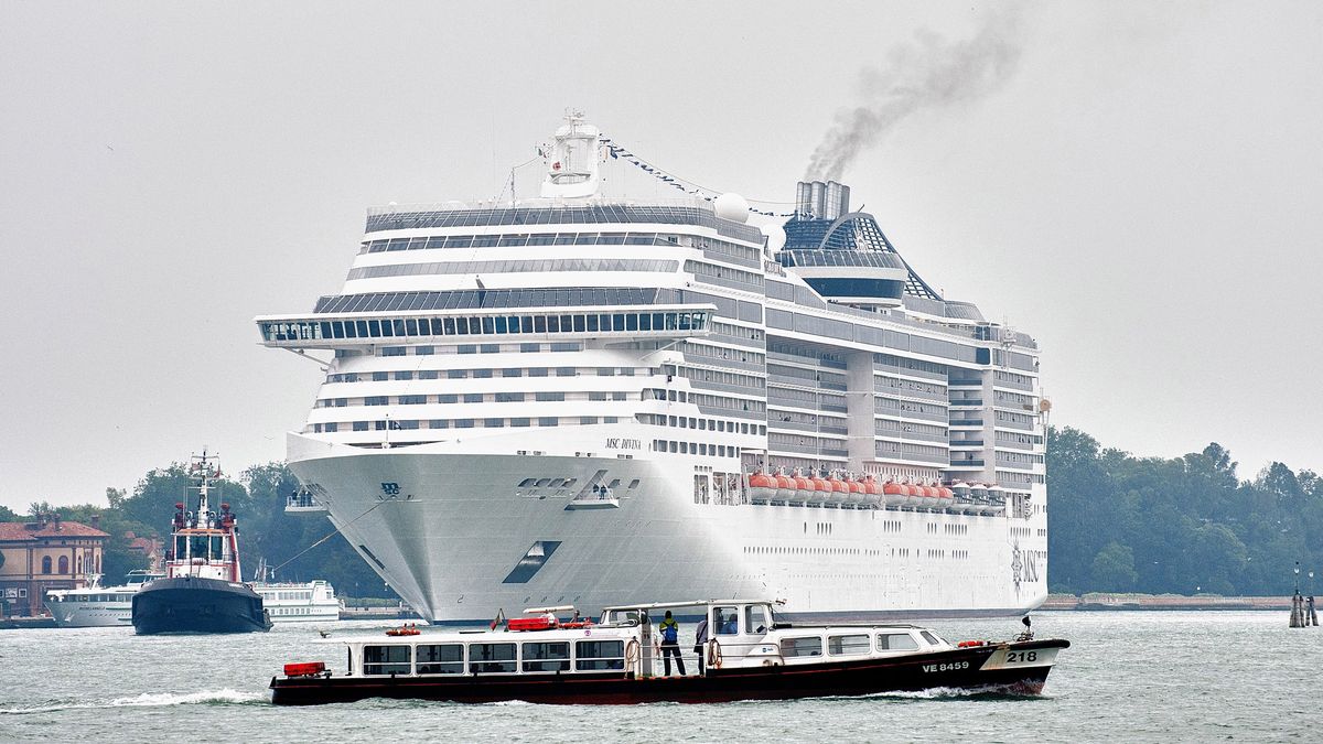 VENICE, ITALY - JUNE 02:  A waterbus cross the way toÊ MSC Divina while she enters St Mark's basin with 139,000 Tonns and nearly 4,000 passengers on June 2, 2012 in Venice, Italy. FAI (Fonto Ambientale Italiano) is now supporting Venetians and environmentalists in their protetst against cruise ships sailing in St Mark's basin, stressing that the increased boat traffic on Venice's waterways increases pollution and damages property.  (Photo by Marco Secchi/Getty Images)