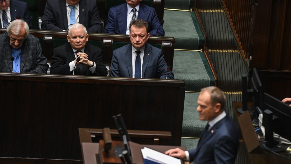 WARSAW, POLAND - DECEMBER 12: Jaroslaw Kaczynski (C), leader of Poland's Law and Justice (PiS) party, looks on as leader of Civic Coalition (KO), Donald Tusk delivers a speech ahead of the vote of confidence on his government cabinet during a session at the parliament (SEJM) on December 12, 2023 in Warsaw, Poland. on December 12, 2023 in Warsaw, Poland. After eight years of Poland's national conservative party in power, centrist Donald Tusk is back and set to forge a pro-EU government. (Photo by Omar Marques/Getty Images)