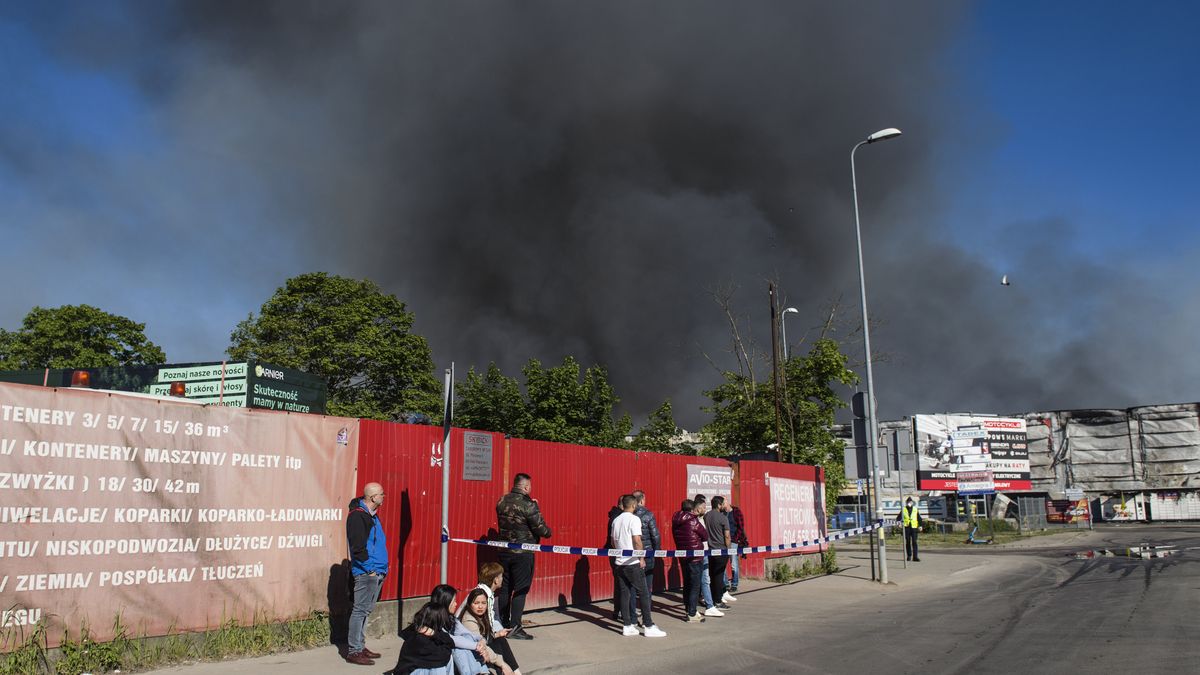 WARSAW, MASOVIAN VOIVODESHIP, POLAND - 2024/05/12: Black smoke seen in the sky above the burning Marywilska 44 shopping center in Warsaw. A massive fire broke out at the Marywilska 44 shopping center in Warsaw's Biaoleka district. According to the State Fire Service, there are 50 fire brigades on site, with a total of nearly 300 firefighters working there, including from the chemical unit. Water is drawn from a nearby canal to extinguish the fire. About 1400 shops are completely burnt down so far. Residents of Warsaw and the surrounding area received a government security center alert, urging them to stay at home and close their windows. (Photo by Attila Husejnow/SOPA Images/LightRocket via Getty Images)