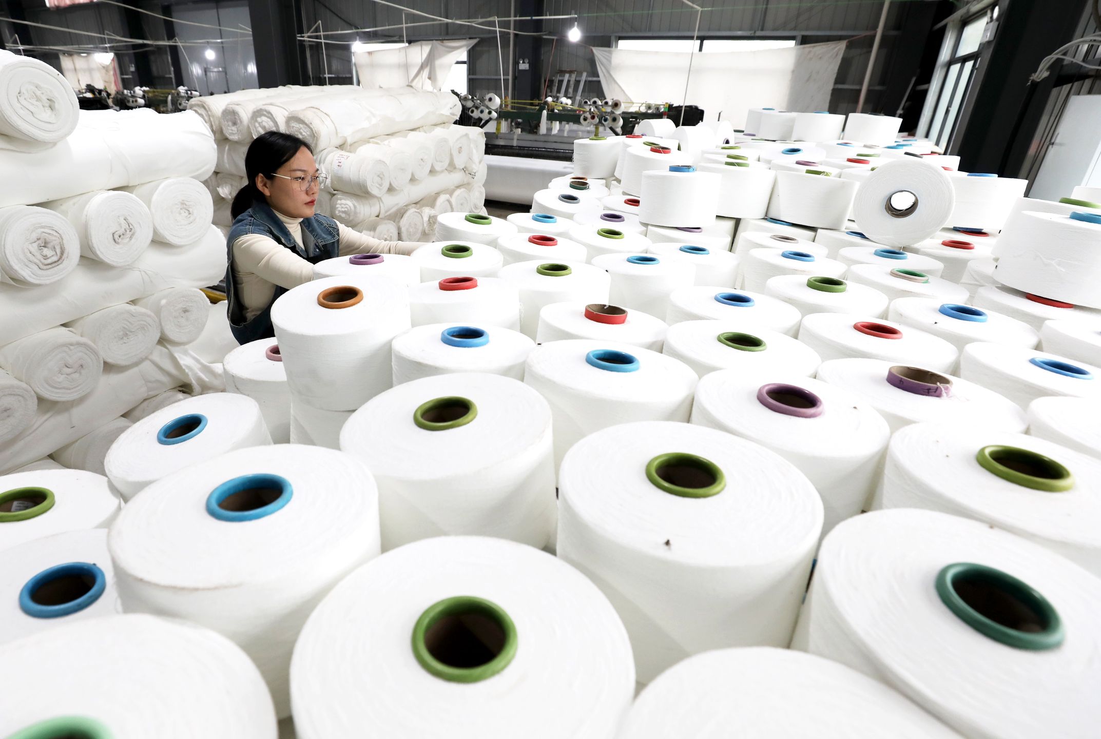 HUAIBEI, CHINA - NOVEMBER 16: An employee works on the production line at a textile factory November 16, 2024 in Huaibei, Anhui Province of China. (Photo by Li Xin/VCG via Getty Images)