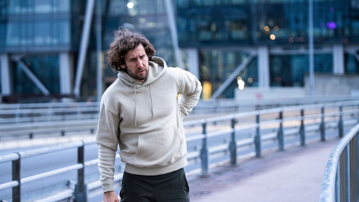 Young male athlete having a backache.
Exhausted young sportsman having a backache while running in the city on cold weather.
DjelicS