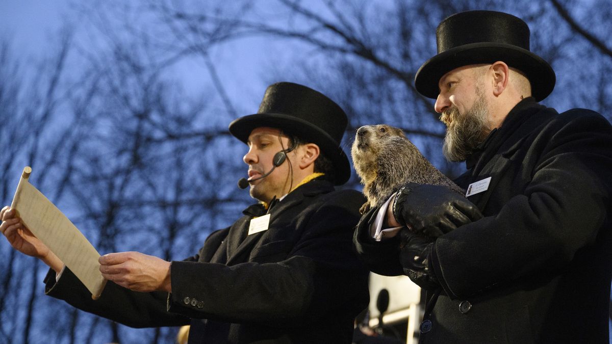 PUNXSUTAWNEY, PA - FEBRUARY 2: Groundhog Day Inner Circle Vice President Dan McGinley announces the weather prognostication as groundhog handler AJ Dereume holds Punxsutawney Phil after he did not see his shadow predicting an early Spring during the 138th annual Groundhog Day festivities on Friday February 2, 2024 in Punxsutawney, Pennsylvania. Groundhog Day is a popular tradition in the United States and Canada. Over 40,000 people spent a night of revelry awaiting the sunrise and the groundhog's exit from his winter den. If Punxsutawney Phil sees his shadow he regards it as an omen of six more weeks of bad weather and returns to his den. Early spring arrives if he does not see his shadow, causing Phil to remain above ground. (Photo by Jeff Swensen/Getty Images)