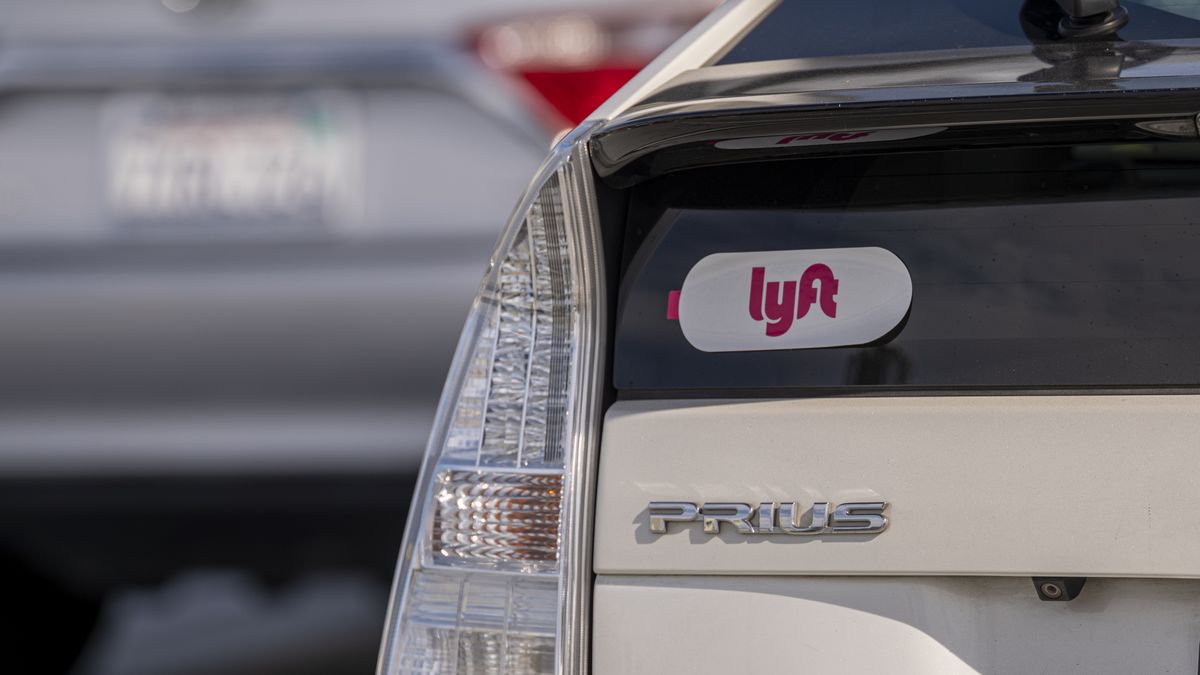 Lyft signage on a vehicle as it exits the ride-sharing pickup at San Francisco International Airport in San Francisco, California, U.S., on Thursday, Feb. 3, 2022. Lyft Inc. is scheduled to release earnings figures on February 8.  Photographer: David Paul Morris/Bloomberg via Getty Images