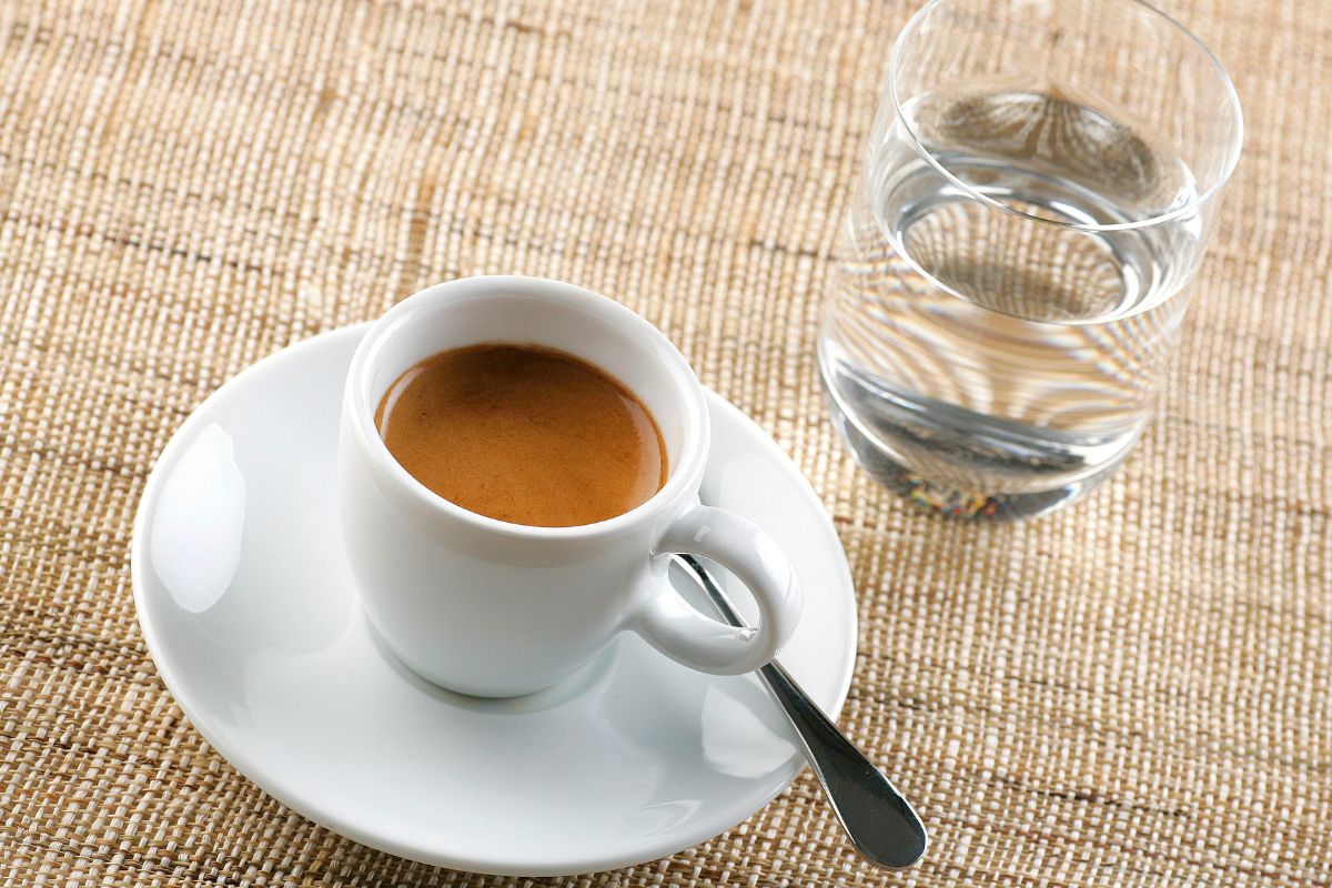 Why is water served with espresso?