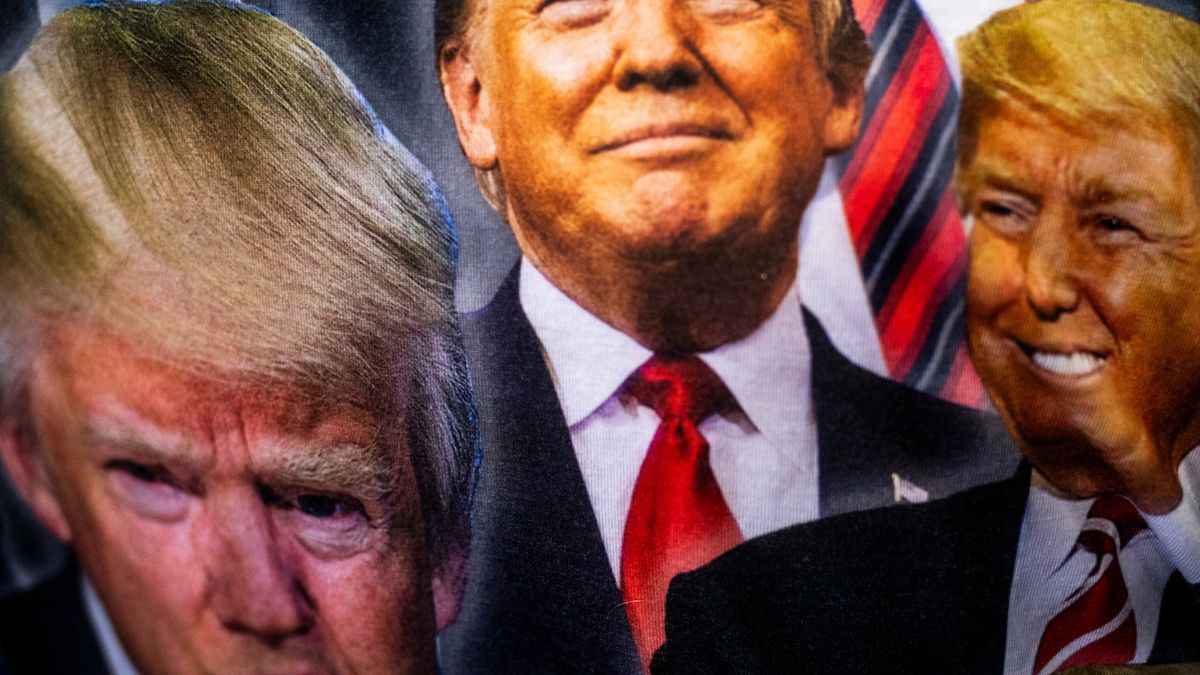 An attendee wears a shirt depicting the face of former US President Donald Trump prior to a campaign event at Alro Steel in Potterville, Michigan, US, on Thursday, Aug. 29, 2024. Trump appears to be taking an even deeper dive into the digital-asset world, saying that he'll unveil plans to ensure that the US will be the "crypto capital of the planet." Photographer: Emily Elconin/Bloomberg via Getty Images