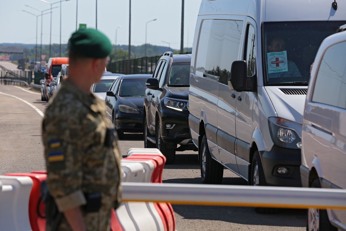 LVIV REGION, UKRAINE - JUNE 20, 2022 - A border guard looks at cars queueing at the Krakovets-Korczowa checkpoint at the Ukraine-Poland border that was upgraded under the Open Border project, Lviv Region, western Ukraine. Ukraine and Poland have agreed to enhance capacity at the Krakovets-Korczowa checkpoint by at least 50% in the coming weeks as part of the Open Border project, including by increasing the number of lanes for trucks and creating additional pavilions for customs and passport control. This photo cannot be distributed in the Russian Federation. (Photo credit should read Alona Nikolaievych/Ukrinform/Future Publishing via Getty Images)