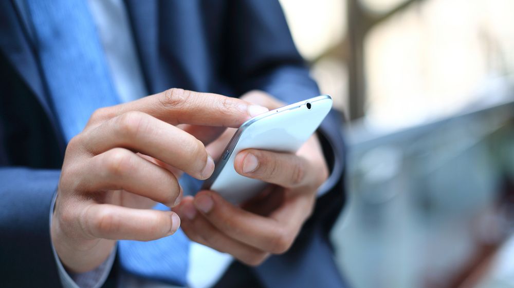 Biznesmen ze smartfonem z depositphotos