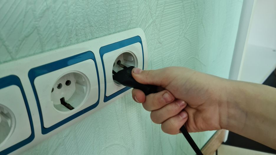 Closeup of child holding hand and inserting plug into outlet
Closeup of child holding hand and inserting plug into outlet. Power line with switches and sockets and child.
Nadzeya Haroshka