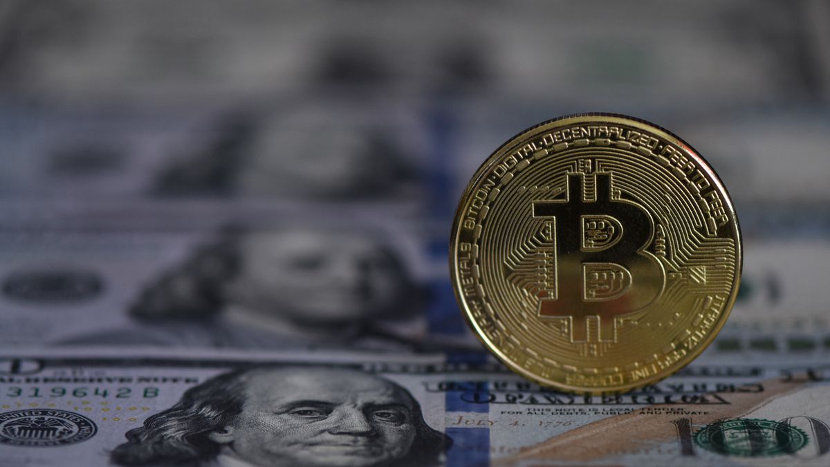 FUYANG, CHINA - JUNE 26, 2022 - Photo taken on June 26, 2022 shows US dollars and bitcoin in Fuyang, Anhui Province, China. (Photo credit should read CFOTO/Future Publishing via Getty Images)