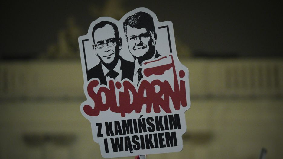 People are seen taking part in a rall in support of two detained politicians in Warsaw, Poland on 10 January, 2024. Over a hundred people joined a protest against the arrest of Maciej Wasik and Mariusz Kaminski, two former officials of the anti-corruption bureau CBA. Kaminski and Wasik have been detained on charges of abuse of power. On Tuesday both sought refuge in the Presidential Palace where they were finally arrested in the evening. (Photo by Jaap Arriens/NurPhoto via Getty Images)