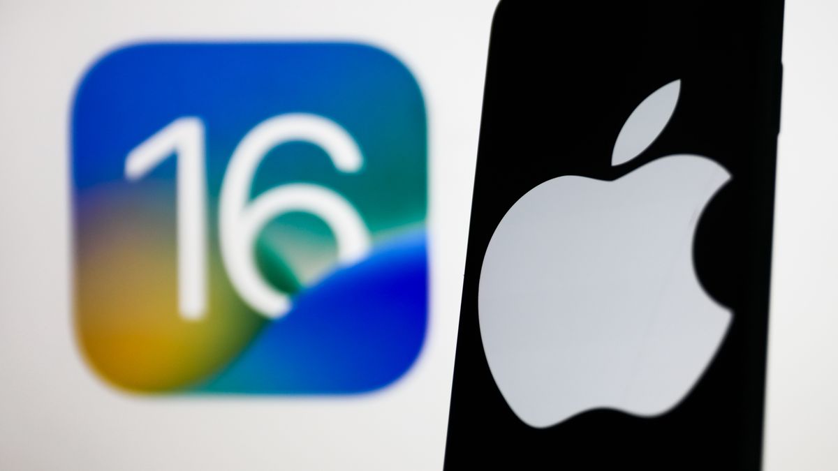 Apple logo displayed on a phone screen and iOS 16 logo displayed on a screen in the background are seen in this illustration photo taken in Krakow, Poland on June 6, 2022. (Photo by Jakub Porzycki/NurPhoto via Getty Images)