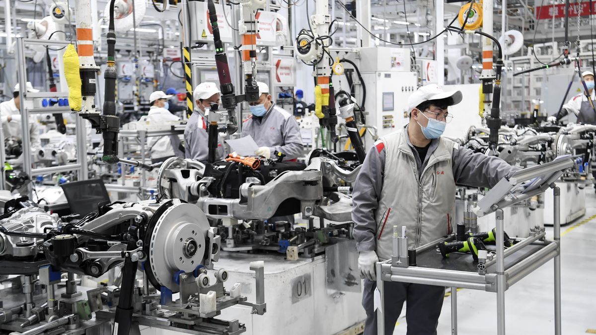 CHANGCHUN, CHINA - DECEMBER 11, 2022 - Workers work diligently on a production line in Changchun, Jilin province, China, Nov 11, 2022. This new factory of Hongqi Manufacturing Department, transformed from the old industrial base of FAW, has three main production lines, with a total construction area of 19,300 square meters and a standard annual production capacity of 62,000 units. It is mainly responsible for the final assembly of Hongqi H7 luxury cars and HS7 high-end SUVs, gathering the product essence of the new Hongqi brand. This assembly workshop, only 129 front-line workers can easily run, intelligent station accounts for more than 80% of the total number of stations. A digital control platform is operated by a master worker who guides a ton of automated robots to assemble components such as engines, chassis, tires and doors in stages. At the same time, the components of the instrument panel assembly line are also unmanned, automatic intelligent distribution system, orderly intelligent delivery, greatly improving the production efficiency and order. (Photo credit should read CFOTO/Future Publishing via Getty Images)