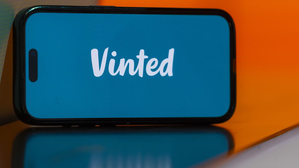 The logo of Vinted UAB on a smartphone arranged in London, UK, on Monday, Nov. 18, 2024. Vinted, Europe's largest online marketplace for second-hand clothes, is ruling out an initial public offering for now as it focuses on expanding beyond fashion. Photographer: Jason Alden/Bloomberg via Getty Images