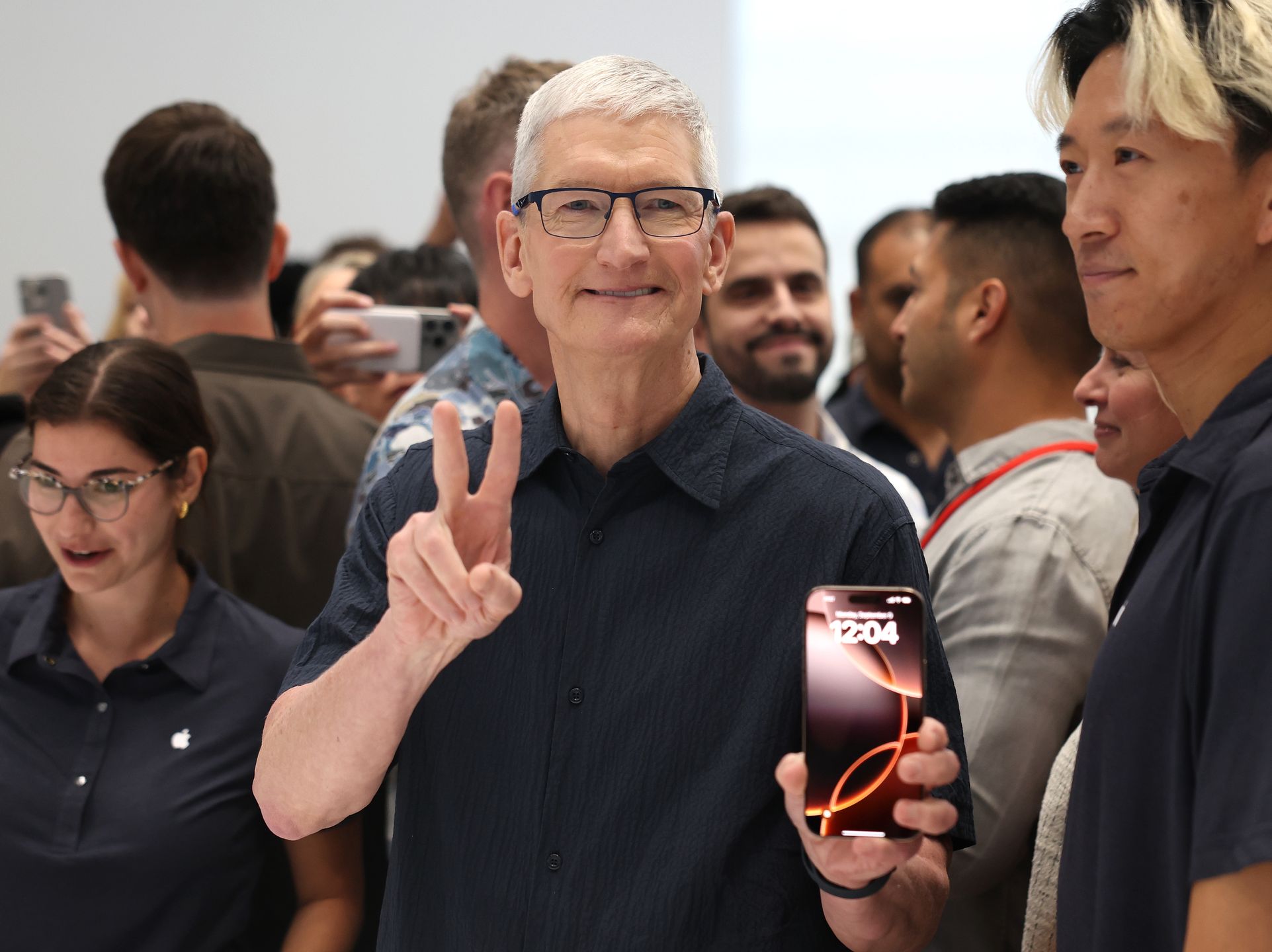 CUPERTINO, CALIFORNIA - SEPTEMBER 09: Apple CEO Tim Cook inspects the new iPhone 16 during an Apple special event at Apple headquarters on September 09, 2024 in Cupertino, California. Apple held an event to showcase the new iPhone 16, Airpods and Apple Watch models. (Photo by Justin Sullivan/Getty Images)