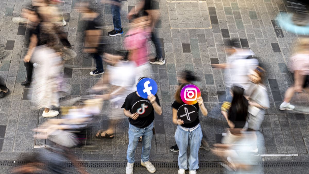 ISTANBUL, TURKIYE - JUNE 08: A man holds the banner of the logos of Facebook and TikTok and a woman holds the banner of the logo of Instagram and X in Istanbul, Turkiye on June 08, 2024. (Photo by Didem Mente/Anadolu via Getty Images)