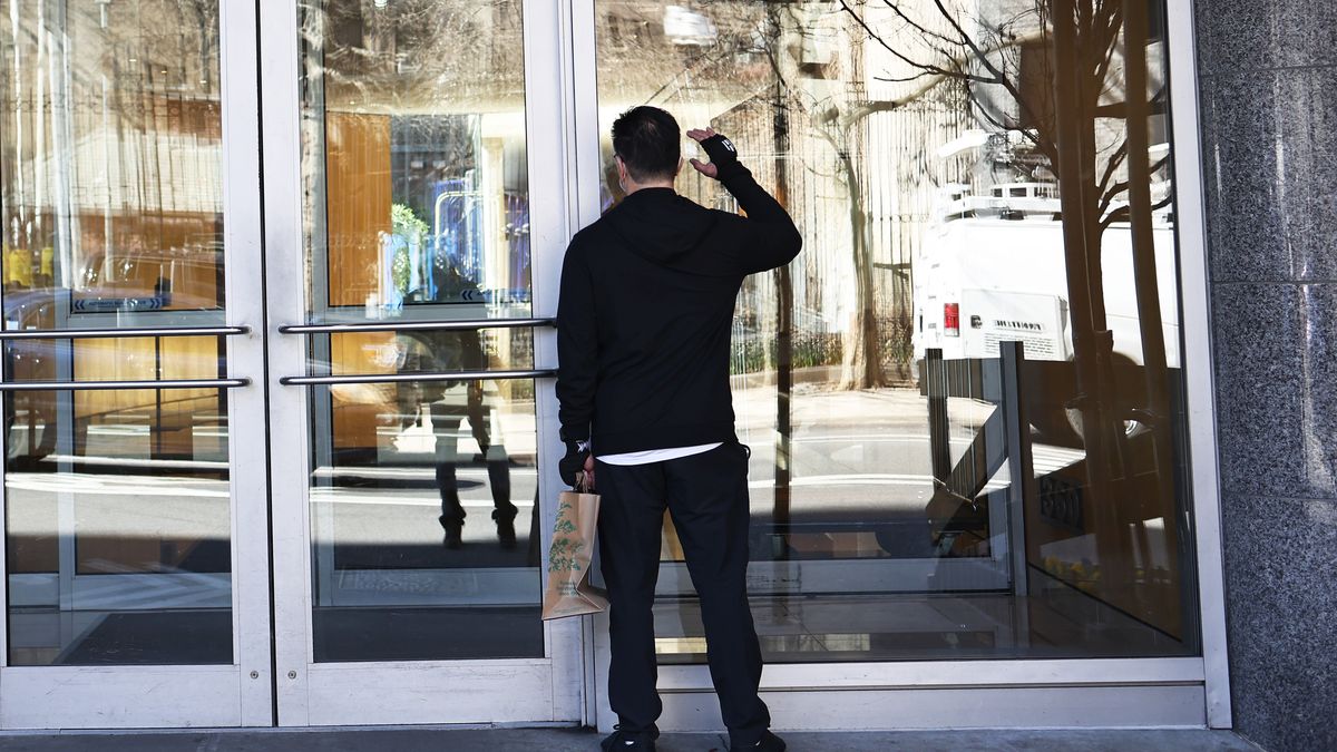 NEW YORK, NEW YORK - MARCH 30: A man looks inside the 360 W 43rd Street building in Midtown Manhattan on March 30, 2021 in New York City. On Monday morning, an unidentified man attacked a 65-year old woman knocking her to the ground and stomping on her head several times and made anti-Asian remarks. NYPD are calling a targeted hate crime. The victim was hospitalized with serious injuries. Brodsky Organization, which manages the luxury apartment building, have suspended staff members who witnessed the attack but failed to intervene. The attack follows a series of targeted hate crimes against people of Asian descent and has been increasing since the start of the coronavirus (COVID-19) pandemic. (Photo by Michael M. Santiago/Getty Images)