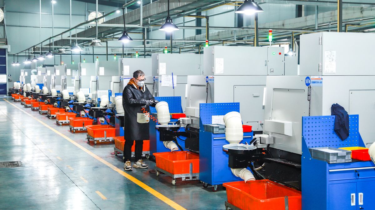 SHAOXING, CHINA - JANUARY 12: An employee works on numerical control lathe at Shaoxing Xuantong Fluid Connectors Manufacturing Co., Ltd. on January 12, 2026 in Shaoxing, Zhejiang Province of China. (Photo by Zhu Shengjun/VCG via Getty Images)