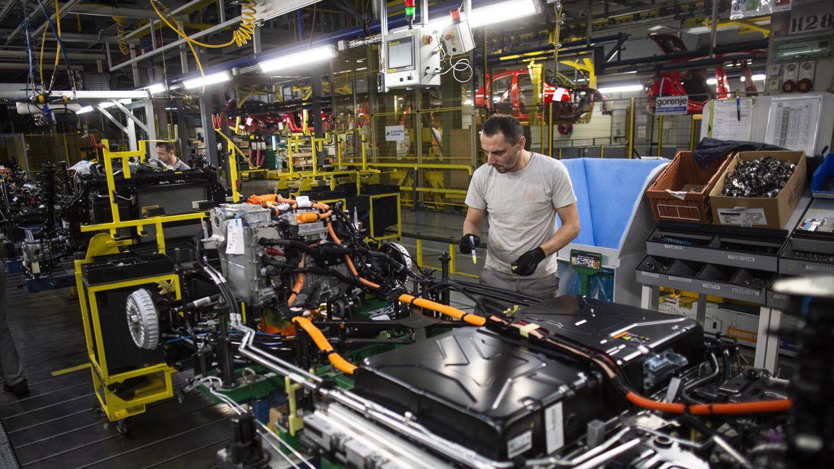 An employee connects the drive train system and battery module to the chassis of a Renault Twingo Electric automobile on the production line at the Renault Revoz d.d. plant, a unit of Renault SA, in Novo Mesto, Slovenia, on Wednesday, Nov. 16, 2022. Renault last week presented a radical overhaul plan to investors, proceeding with a complex split of Renault's electric-vehicle and combustion-engine businesses. Photographer: Oliver Bunic/Bloomberg via Getty Images
