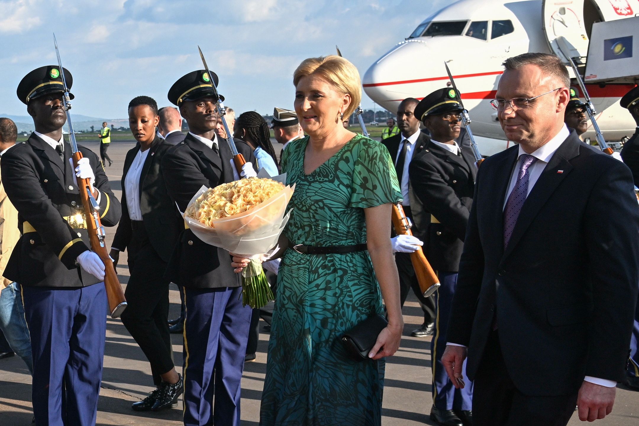 Kigali, Rwanda, 06.02.2024. Wizyta prezydenta RP w Rwandzie. Prezydent RP Andrzej Duda (P) oraz pierwsza dama Agata Kornhauser-Duda (C) podczas powitania na lotnisku w Kigali, 6 bm. Prezydent RP Andrzej Duda z pierwszą damą Agatą Kornhauser-Dudą są z wizytą w Afryce Wschodniej. Odwiedzą trzy państwa: Kenię, Rwandę i Tanzanię. Celami wizyty są promocja polskiego biznesu i współpraca w zakresie bezpieczeństwa. (jm) PAP/Radek Pietruszka