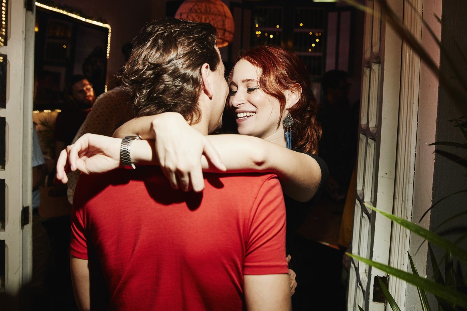 Smiling woman embracing boyfriend during party in night clubThomas Barwick