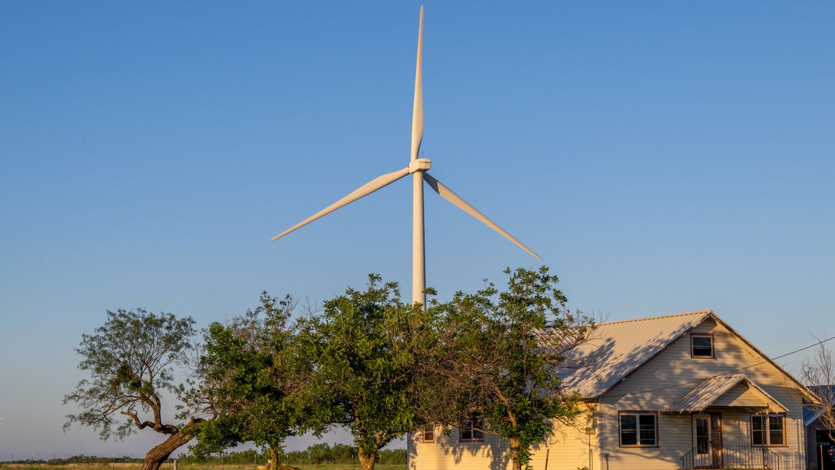 NOLAN, TEXAS - JUNE 28: A wind turbine behind a house at dawn on June 28, 2024 in Nolan, Texas.  (Photo by Brandon Bell/Getty Images)