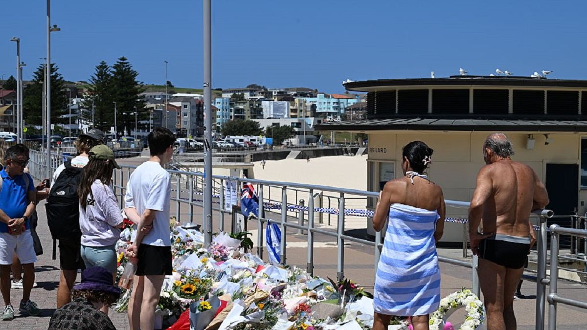 Australia Reacts To Mass Shooting At Bondi Beach
SYDNEY, AUSTRALIA - DECEMBER 17: People look on at flowers laid beside Bondi Beach on December 17, 2025 in Sydney, Australia. Police say at least 16 people, including one suspected gunman, were killed and more than 40 others injured when two attackers opened fire near a Hanukkah celebration at the world-famous Bondi Beach, in what authorities have declared a terrorist incident. The government is moving to tighten gun laws across the country. (Photo by James D. Morgan/Getty Images)
James D. Morgan