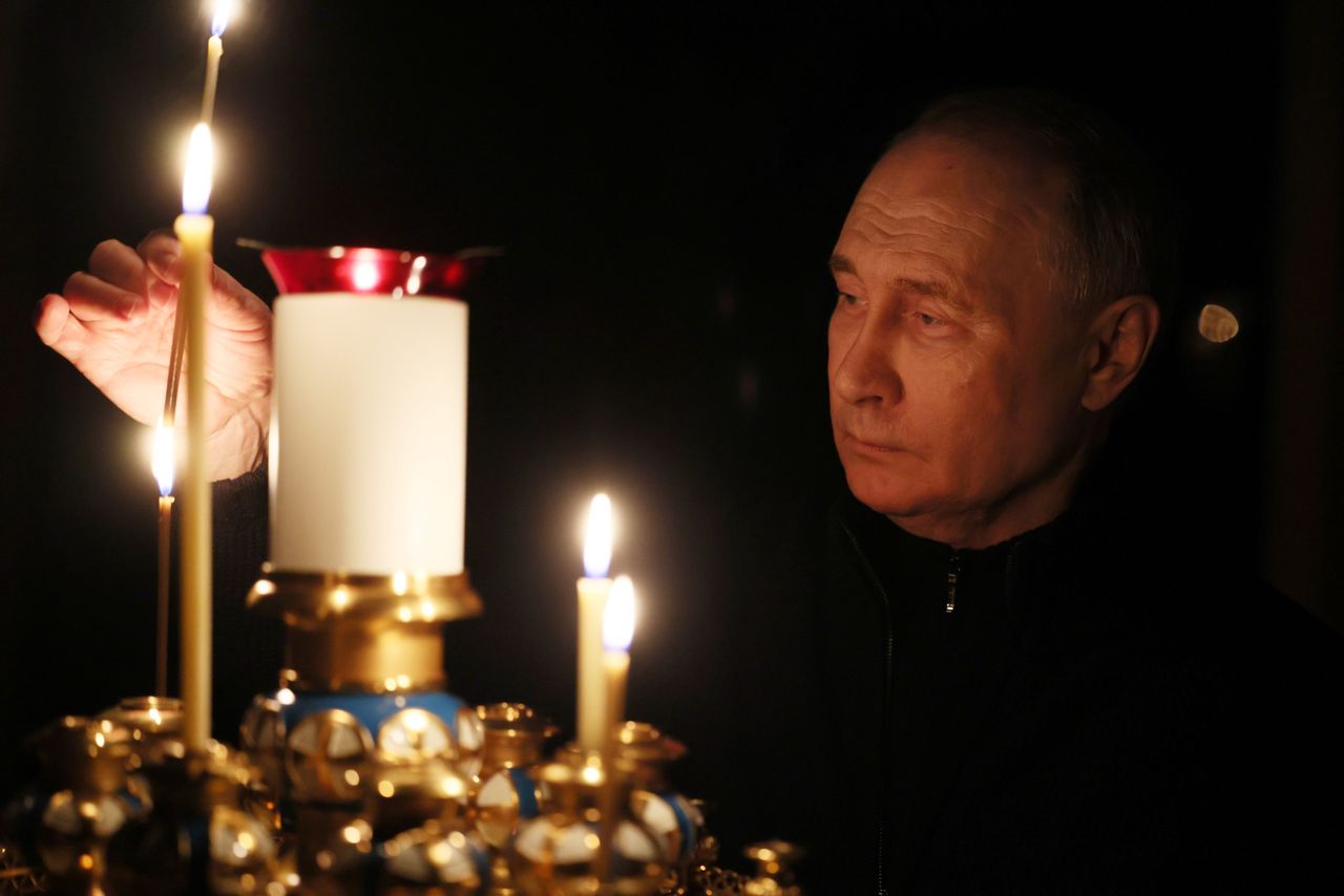 Vladimir Putin lights a candle to commemorate the victims of the terrorist attack on the Crocus City Hall concert hall on the day of national mourning in Moscow, Russia, March 24, 2024.