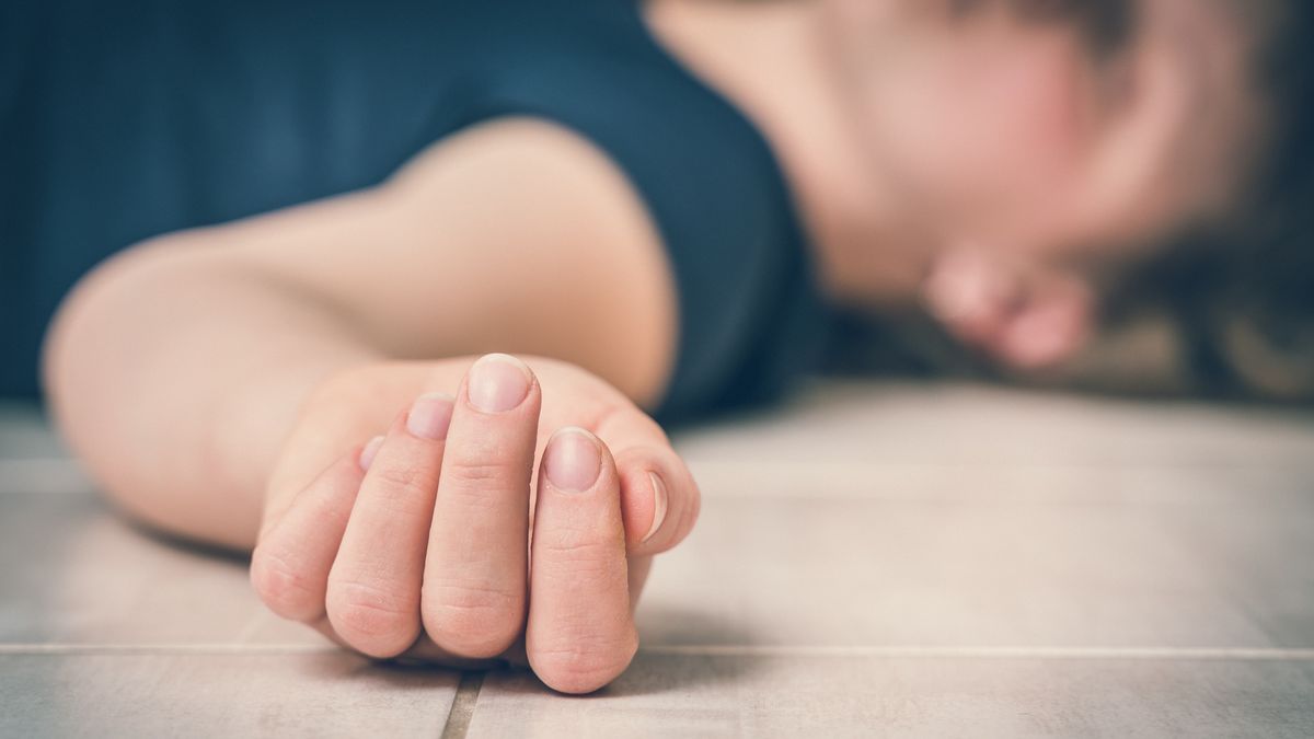 Dead woman lying on the white floor