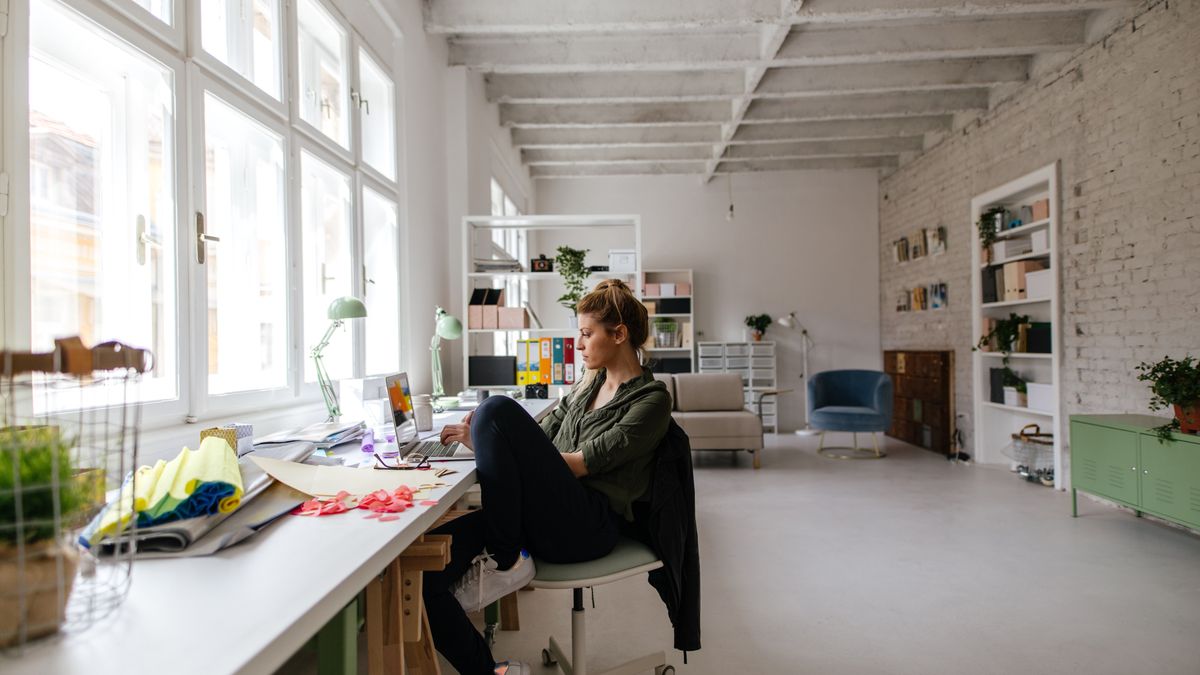 Photo of a woman working online from home office