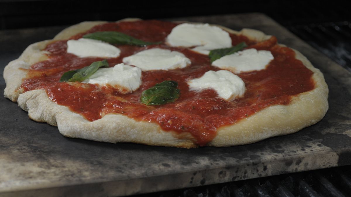 Brown's brown ale pizza dough with home made sauce, fresh mozzarella and fresh basil, cooks on a pizza stone on a grill at  DeFazio's Pizza on Thursday, June 13, 2013 in Troy, NY.   (Photo by Paul Buckowski/Albany Times Union via Getty Images)