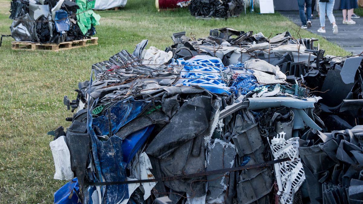 KASSEL, GERMANY - JUNE 15: Visitors stand in front of the installation the 'Nest Collective' from Nairobi at a preview day at the documenta 15 modern art fair on June 15, 2022 in Kassel, Germany. The 'Nest Collective' draws attention to the transport of garbage, e-waste and textiles to the countries of the Global South, which contribute to the destruction of the environment and the economy there, with Return to Sender, a walk-in installation made of trash. The documenta, which takes place every five years, is among Europe's leading art fairs and will be open to the public from June 18 to September 25. (Photo by Thomas Lohnes/Getty Images)