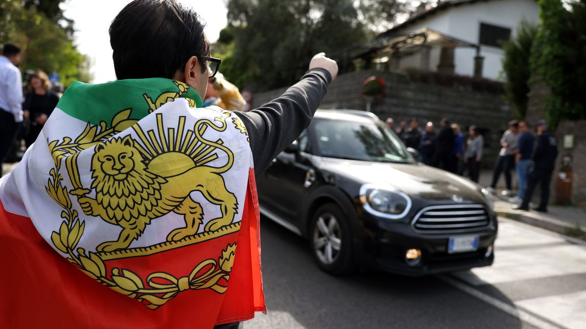 A demonstrator wearing an Iranian national flag protests outside the Omani embassy, in Rome, Italy, on Saturday, April 19, 2025. Iran and the US on Saturday began a second round of talks aimed at reaching a deal over Tehran's nuclear program, according to Iranian state television. Photographer: Alessia Pierdomenico/Bloomberg via Getty Images