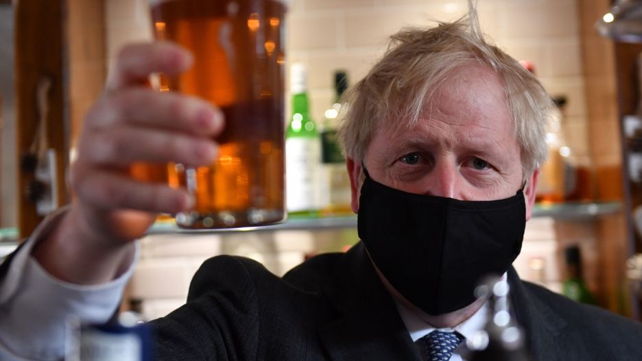 WOLVERHAMPTON, ENGLAND - APRIL 19: Prime Minister Boris Johnson holds up a pint during a visit to The Mount pub and restaurant on April 19, 2021 in Wolverhampton, United Kingdom. The Prime Minister is on the local election campaign trail in West Midlands, (Photo by Jacob King - WPA Pool/Getty Images)