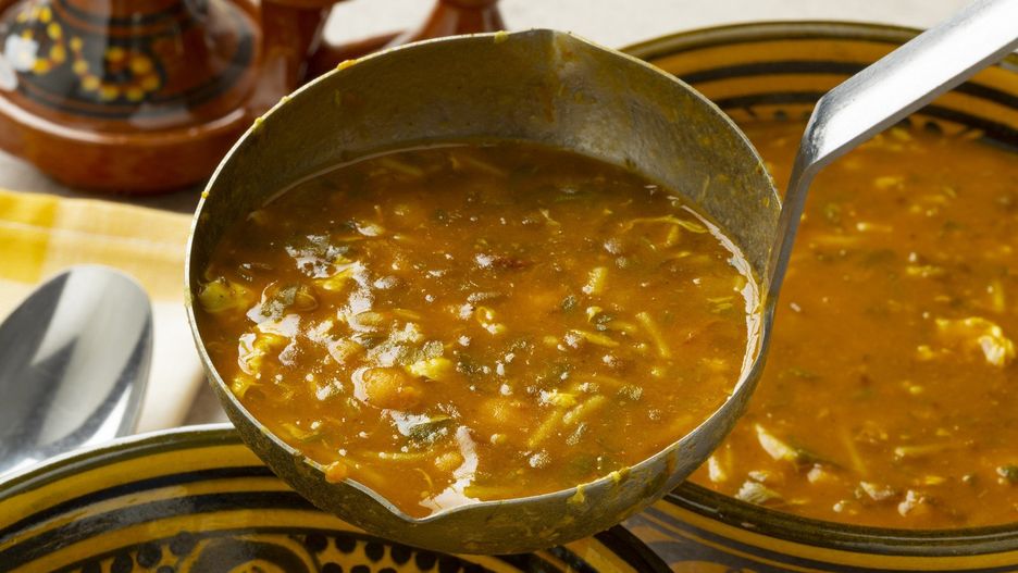 Serving Moroccan harira soup close up
