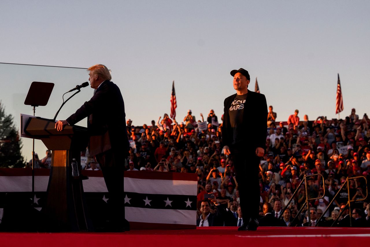 Elon Musk, chief executive officer of Tesla Inc., right, and former US President Donald Trump during a campaign event at the Butler Farm Show in Butler, Pennsylvania, US, on Saturday, Oct. 5, 2024. Republican nominee Donald Trump rallied supporters at the site of a July assassination attempt, returning to the Pennsylvania venue where a gunman's bullet bloodied his ear and upended the presidential campaign. Photographer: Justin Merriman/Bloomberg via Getty Images