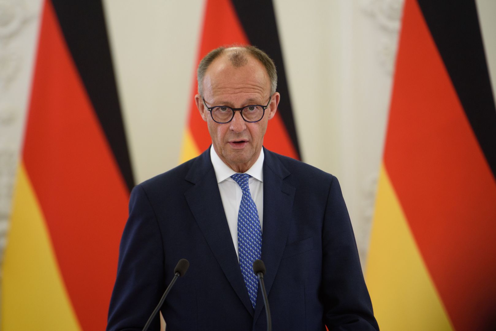 VILNIUS, LITHUANIA - 2025/05/22: German Chancellor Friedrich Merz talks to the media during a press conference after a meeting with Lithuanian President Gitanas Nauseda (not in view) at the Presidential palace. German Federal Chancellor Friedrich Merz held a meeting with Lithuanian President Gitanas Nauseda at the Presidential Palace in Vilnius. His visit to Lithuania was timed to the formal inauguration of the German 45th Armored Brigade "Lithuania.". (Photo by Yauhen Yerchak/SOPA Images/LightRocket via Getty Images)