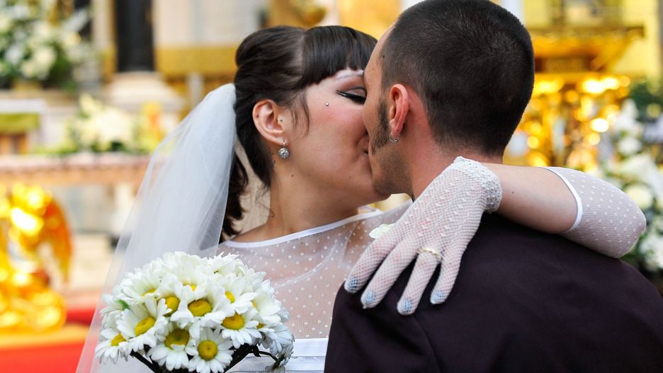 Married couple kissingMarried couple kissing after their wedding ceremony in a church.Giulia Fiori Photography