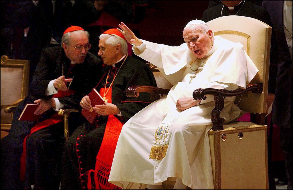 Pope John Paul II signed the Post-Synodal Apostolic Exhortation on the ministry of bishops during a meeting with cardinals and bishops at the Vatican the day of the 25th anniversary of his election in Rome, Italy on October 16th, 2003.
VATICAN - OCTOBER 16:  Cardinals Giovanni Battista Re (L) and Joseph Ratzinger in Rome, Italy on October 16th, 2003.  (Photo by Eric VANDEVILLE/Gamma-Rapho via Getty Images)
Eric VANDEVILLE
Anniversary, Cardinal, Christianity, Color, Color photo, German, Holy Father, Holy See, Italian, Jubilee, Minister of religion, Papacy, Pole, Pope, Religious personality, Sacred College, Salute Gesture, Supreme Pontiff, Synod, Waving, catholic religion Roman Catholic Church, pontiff, pontificate
