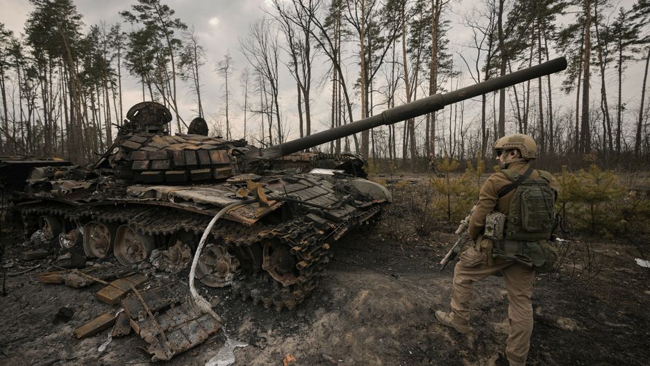 TemporaryA Ukrainian serviceman stands next to a destroyed Russian tank after Ukrainian forces overran a Russian position outside Kyiv, Ukraine, Thursday, March 31, 2022. Heavy fighting raged on the outskirts of Kyiv and other zones Thursday amid indications the Kremlin is using talk of de-escalation as cover while regrouping and resupplying its forces and redeploying them for a stepped-up offensive in eastern Ukraine.(AP Photo/Vadim Ghirda)AP