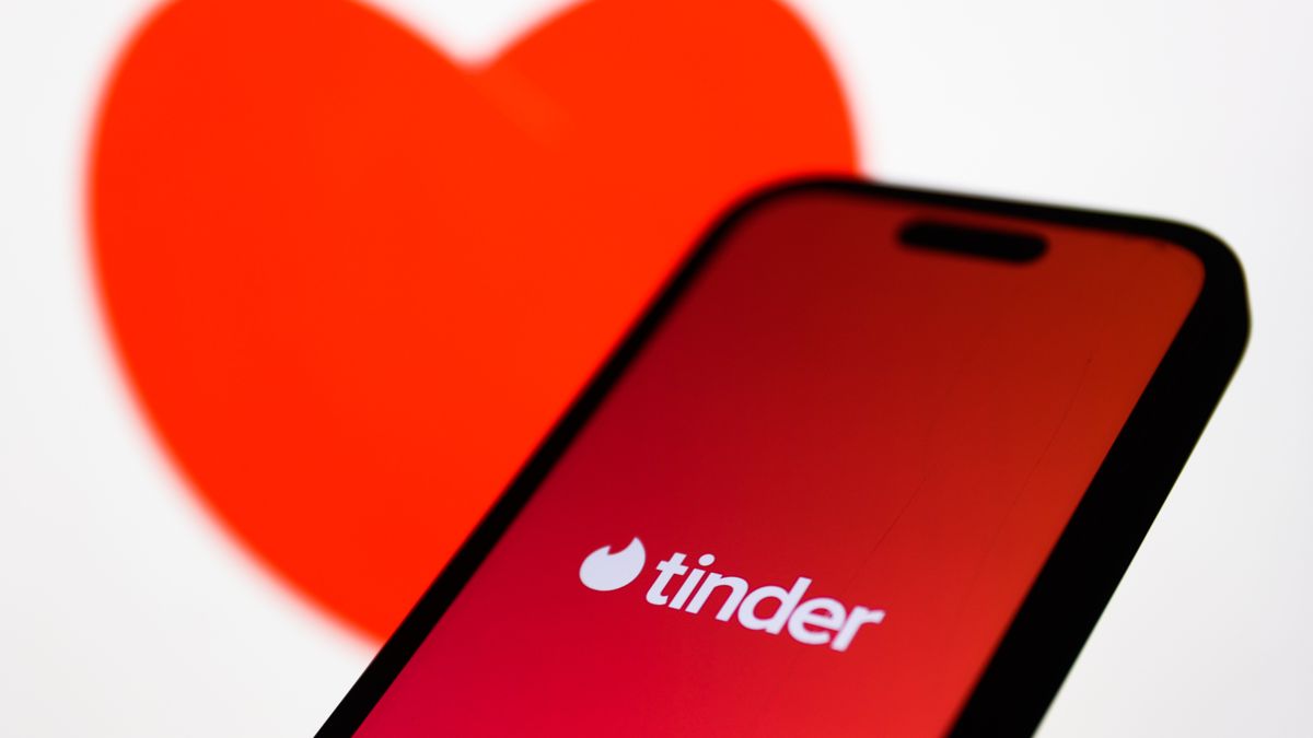 An image of heart displayed on a laptop screen and Tinder logo displayed on a phone screen are seen in this illustration photo taken in Krakow, Poland on February 21, 2024. (Photo by Jakub Porzycki/NurPhoto via Getty Images)