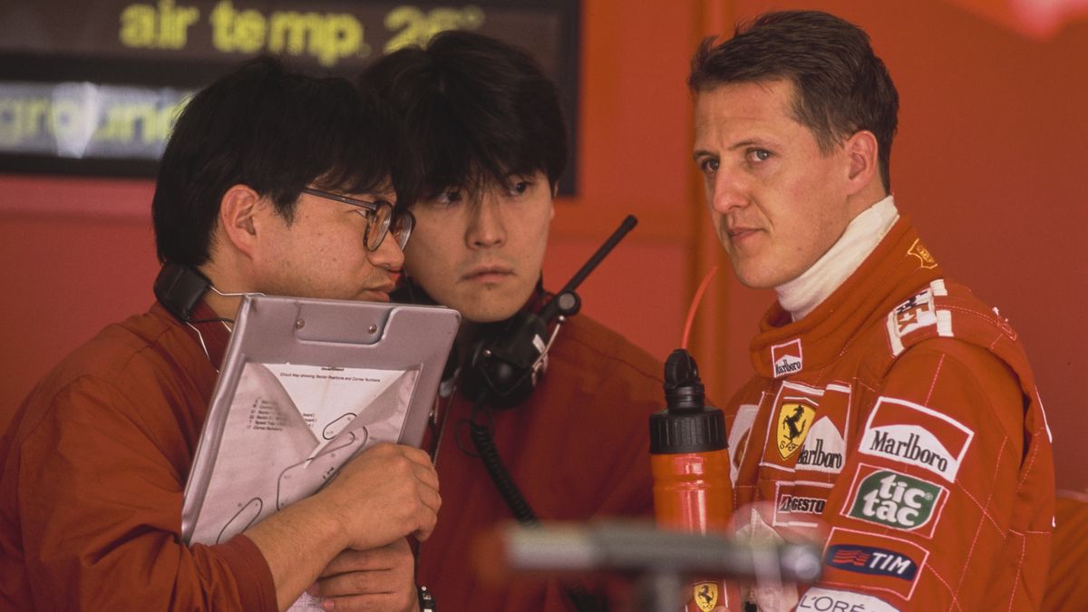 Michael Schumacher from Germany, driver of the #1 Scuderia Ferrari Marlboro Ferrari F1-2001 Ferrari V10 in conversation with two Bridgestone tyre technicians during practice for the Formula One Spanish Grand Prix on 28th April 2001 at the Circuit de Barcelona-Catalunya, Barcelona, Spain.   (Photo by Andreas Rentz/Bongarts/Getty Images)