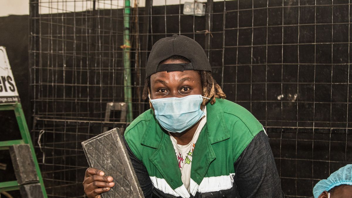 NAIROBI, KENYA - 2022/02/26: Kenyan Nzambi Matee, the founder of Gjenge Makers ltd, poses for photographs holding a brick made of recycled plastics at her recycling plant.Discussions to chart a way forward for a global plastic treaty to address the growing plastic pollution problem will begin this week during the United Nations Environmental Assembly UNEA 5.2). With two draft resolutions on the table, member countries will address the entire life cycle of plastics proposed by Rwanda and Peru or Japan's draft resolution that emphasizes better plastic waste management. More than 50 countries and environmental groups support regulations that impose caps on virgin plastics production. (Photo by James Wakibia/SOPA Images/LightRocket via Getty Images)