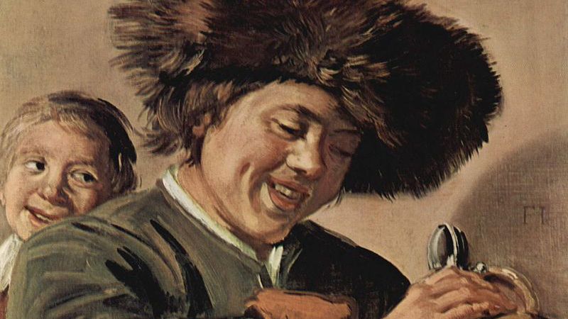 "Dwóch śmiejących się chłopców z kuflem piwa"
