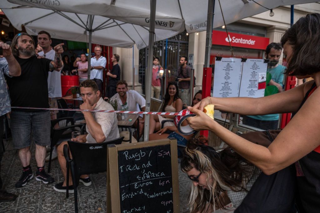 The protesters surrounded some restaurants with tape.