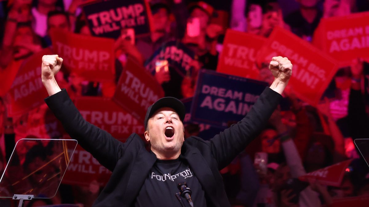 NEW YORK, NEW YORK - OCTOBER 27: Tesla and X CEO Elon Musk raises his hands as he takes the stage during a campaign rally for Republican presidential nominee, former U.S. President Donald Trump, at Madison Square Garden on October 27, 2024 in New York City. Trump closed out his weekend of campaigning in New York City with a guest list of speakers that includes his running mate Republican Vice Presidential nominee, U.S. Sen. J.D. Vance (R-OH), Tesla CEO Elon Musk, UFC CEO Dana White, and House Speaker Mike Johnson, among others, nine days before Election Day.  (Photo by Michael M. Santiago/Getty Images)