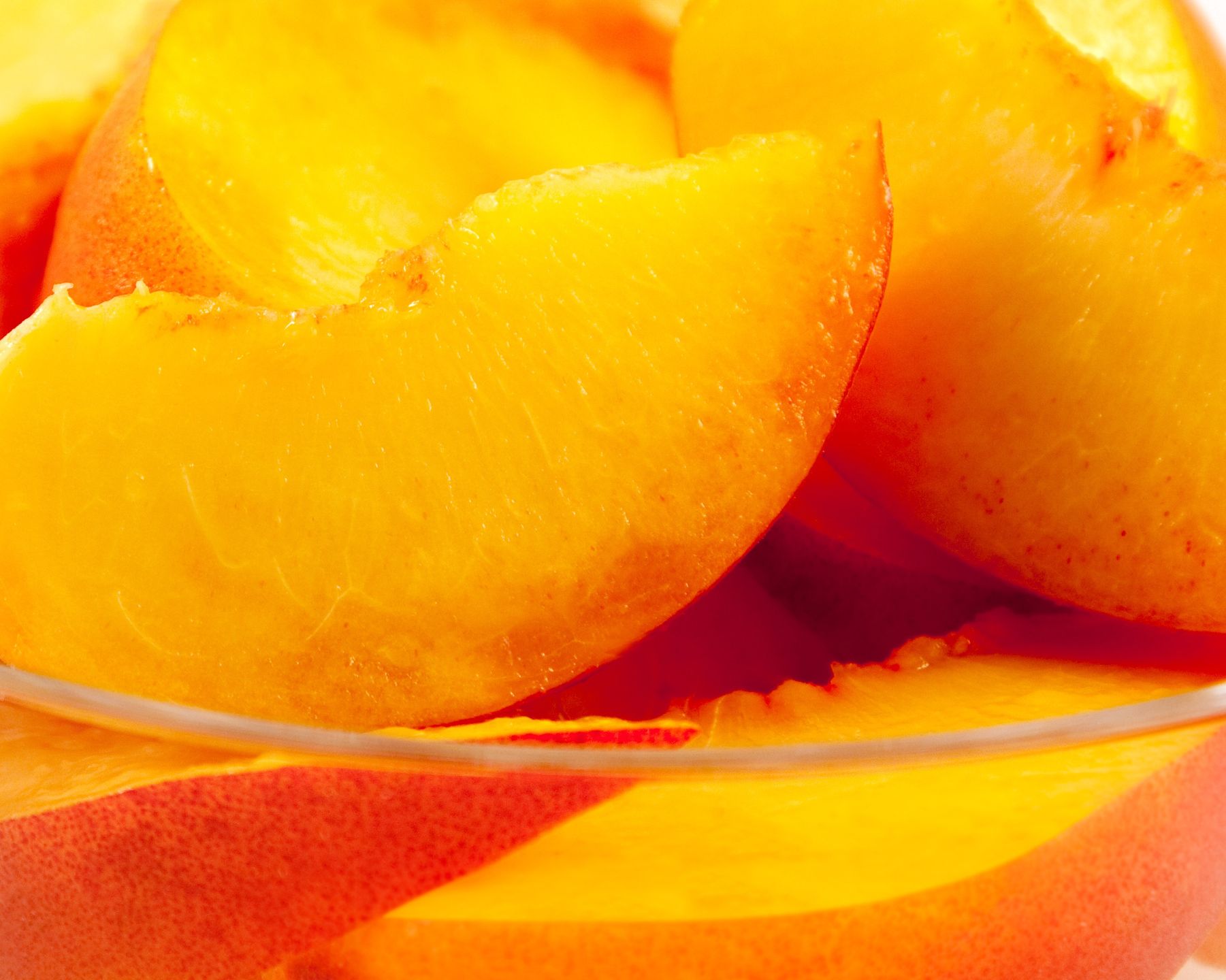 Bowl of Sliced PeachesBowl of fresh sliced peaches aa shallow depth of field.HelpingHandPhotos"Glass Bowl, Close-up, Food And Drink, Freshness, Fruit, Fruits And Vegetables", Group of Objects, Healthy Eating, Juicy, Nobody, Nutrient, Orange, Part Of, Peach, Photography, Portion, Ripe, Snack, Square, Studio Shot