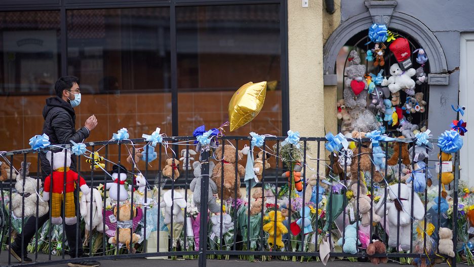 WALSALL, ENGLAND - APRIL 07: People place flowers and tributes at the scene where baby Ciaran Lee Morris was killed in Brownhills High Street. April 07, 2021 in Walsall, England. A two-week-old baby boy, Ciaran Lee Morris, was killed when a car mounted the pavement and struck his pram pinning it and the baby's mother, Codie Holyman, to a wall in Brownhills on Sunday afternoon. West Midlands Police arrested 34-year-old James Paul Davis in Bloxwich shortly afterwards. He appeared in court charged with causing death by driving while uninsured, failing to stop at the scene of a collision and failure to report a collision. (Photo by Christopher Furlong/Getty Images)