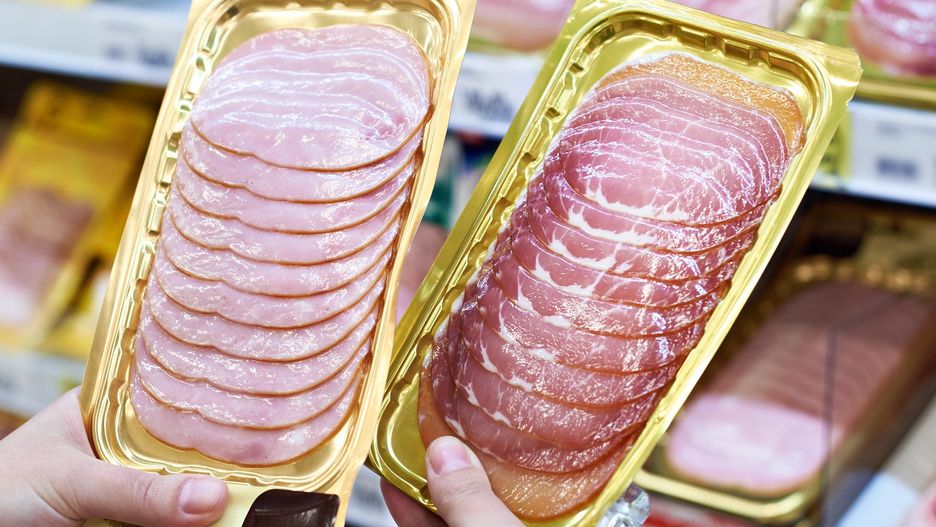 Woman chooses slice of ham at storeWoman chooses a slice of ham and meat  in vacuum package at the grocery storesergeyryzhovvacuum, hands, female