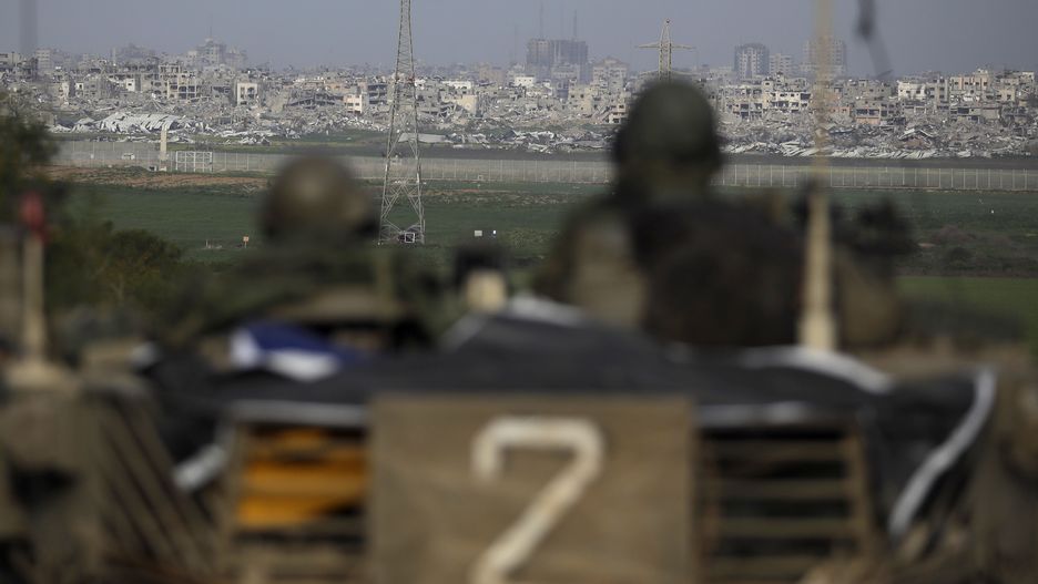 SOUTHERN ISRAEL, ISRAEL - FEBRUARY 14:  Israeli soldiers stand on a tank as they patrol near the border with Gaza on February 14, 2024 in Southern Israel, Israel. As Israel examines the details of a fresh truce agreement with Hamas, there is mounting pressure on the Netanyahu government over handling of events since the Oct. 7th attacks and returning the hostages to Israel from Gaza.  (Photo by Amir Levy/Getty Images)