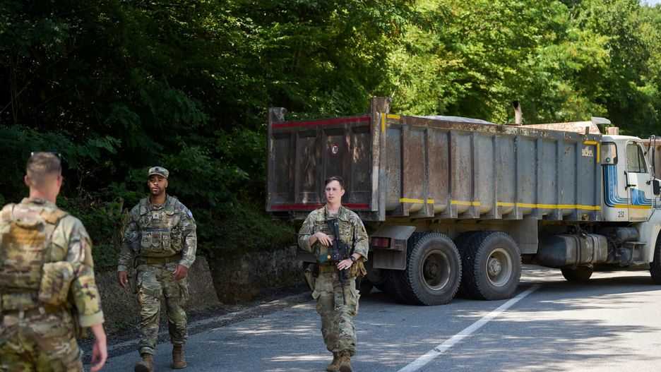 Temporary
US NATO soldiers serving in Kosovo patrol next to a road barricade set up by ethnic Serbs near the town of Zubin Potok on August 1, 2022. - Kosovo's government late on July 31, 2022, postponed for a month the implementation of new border rules that sparked tensions in the north of the country where ethnic Serbs blocked roads and unknown gunmen fired on police. (Photo by Armend NIMANI / AFP)
ARMEND NIMANI